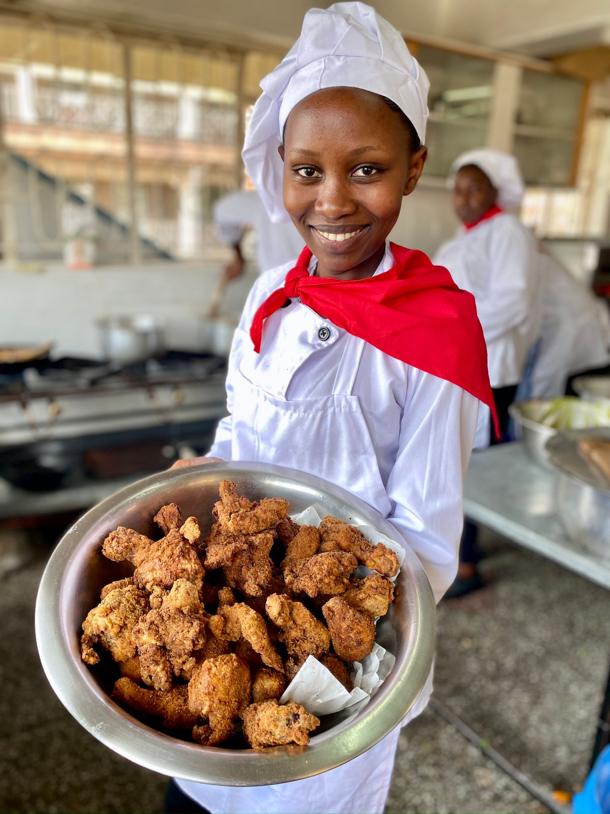 Cookery and pastry student holding prepared food